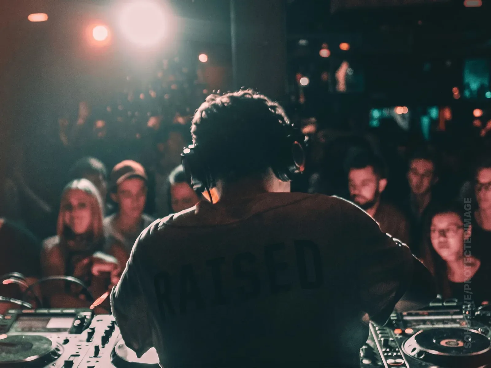 DJ Behind the Decks Facing the Crowd