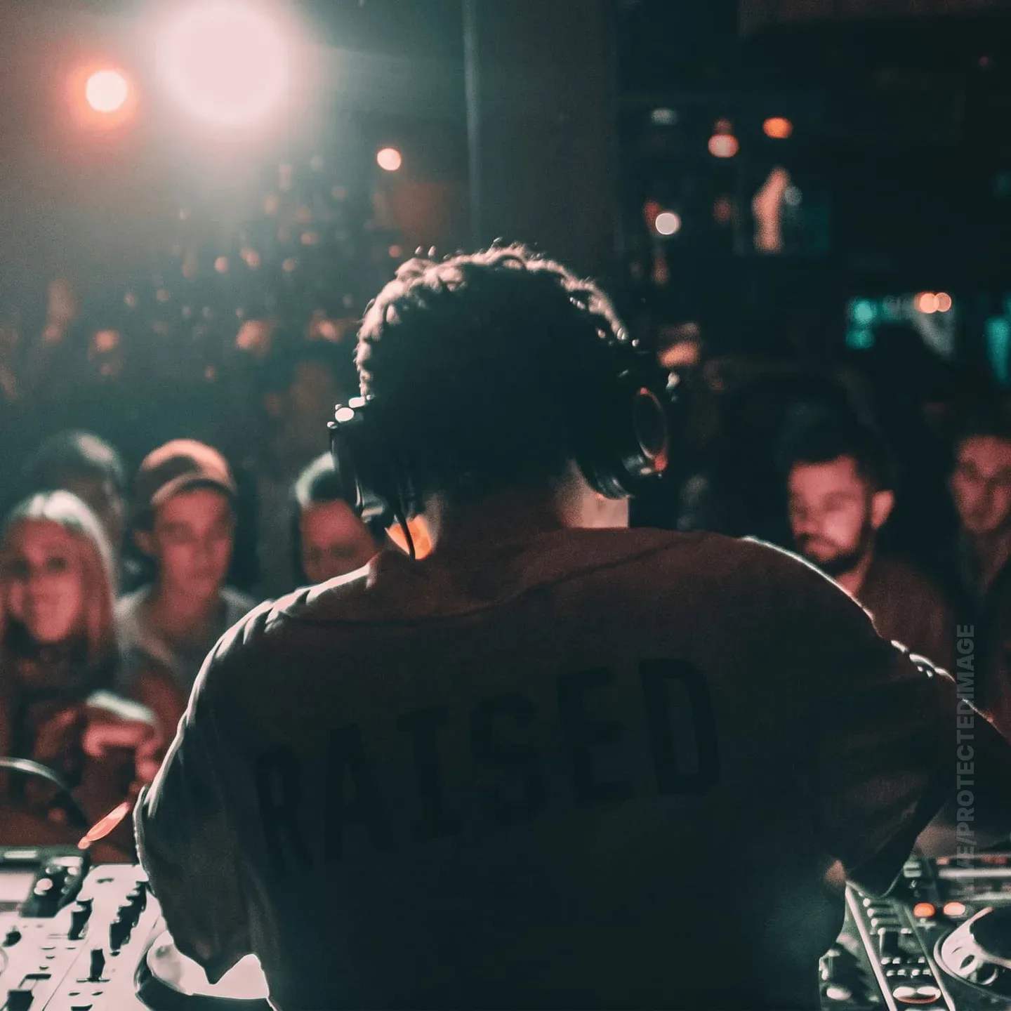 DJ Behind the Decks Facing the Crowd