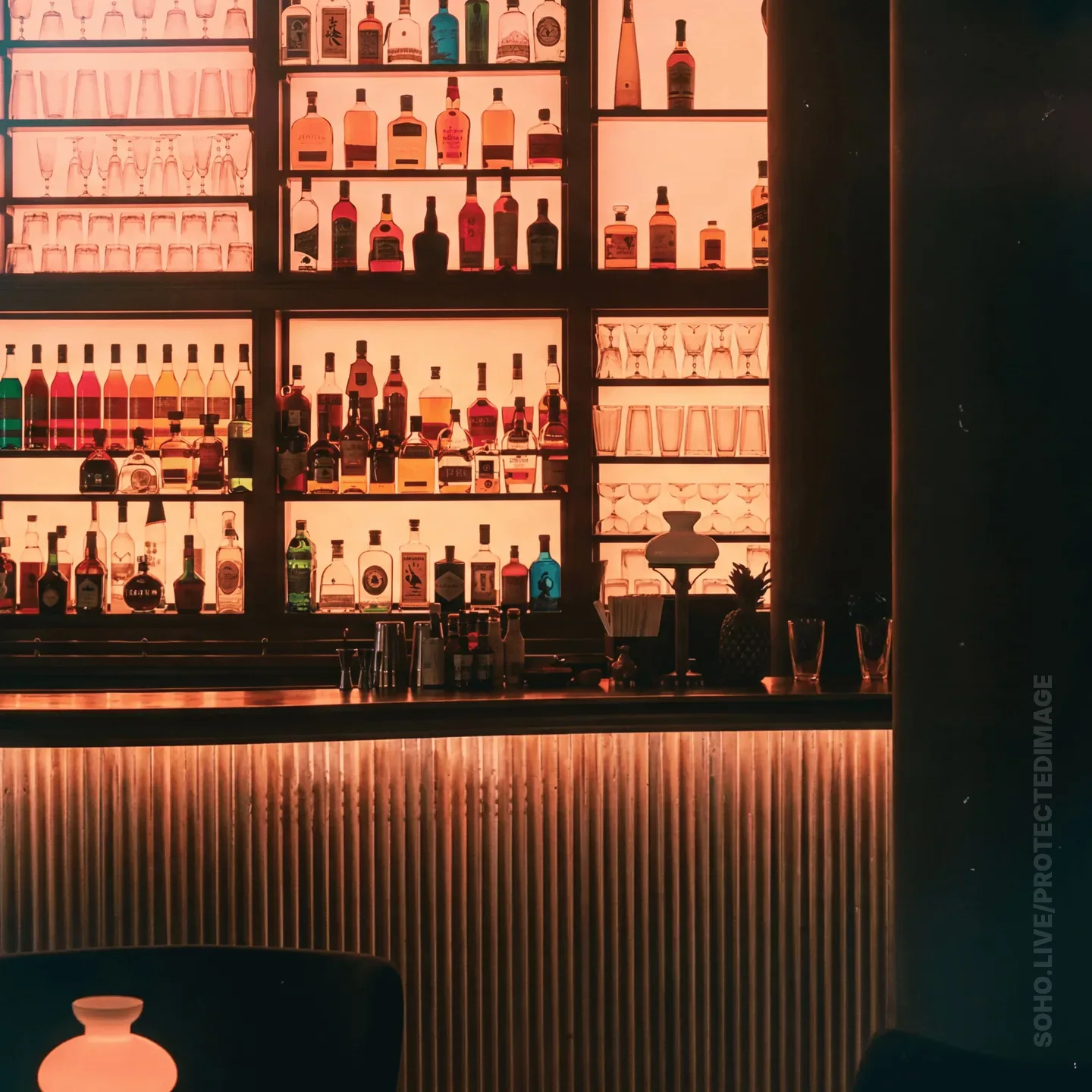 Intimate Backlit Cocktail Bar at Night