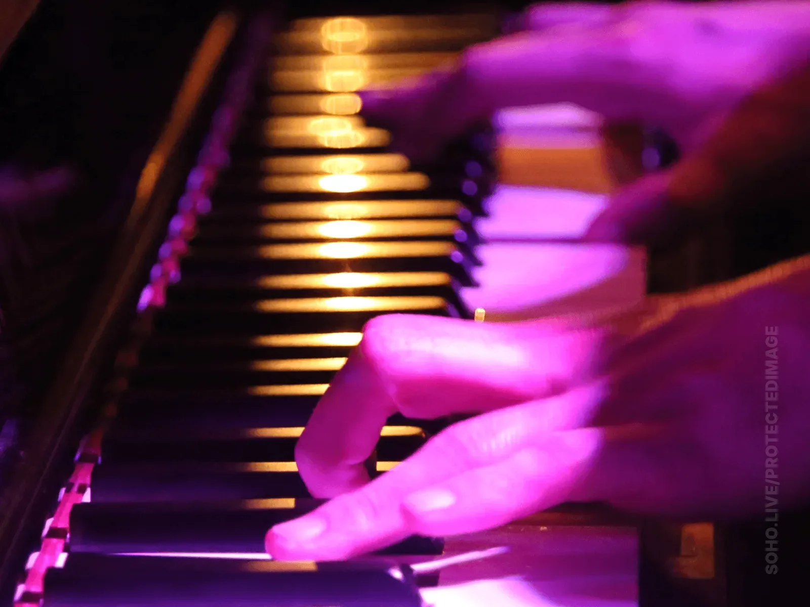 Piano Keys Glowing Under Stage Light