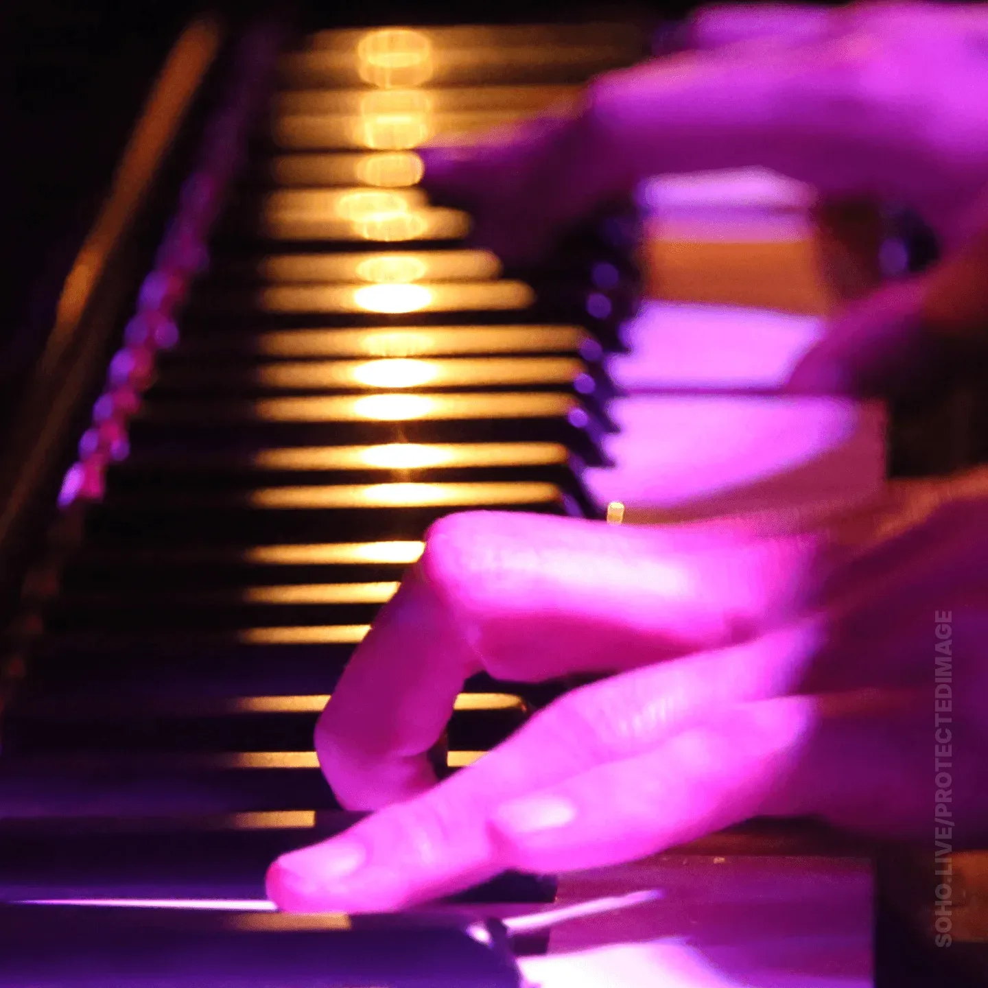 Piano Keys Glowing Under Stage Light