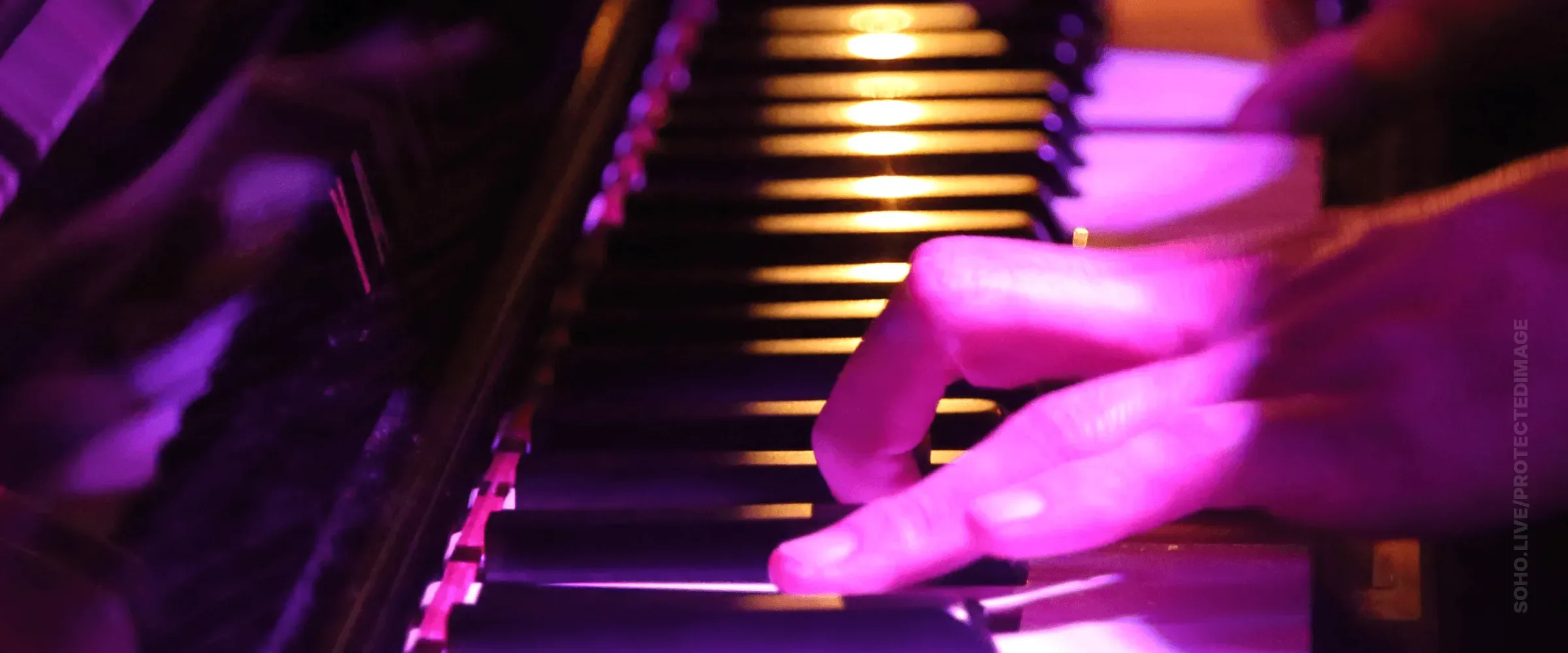 Piano Keys Glowing Under Stage Light