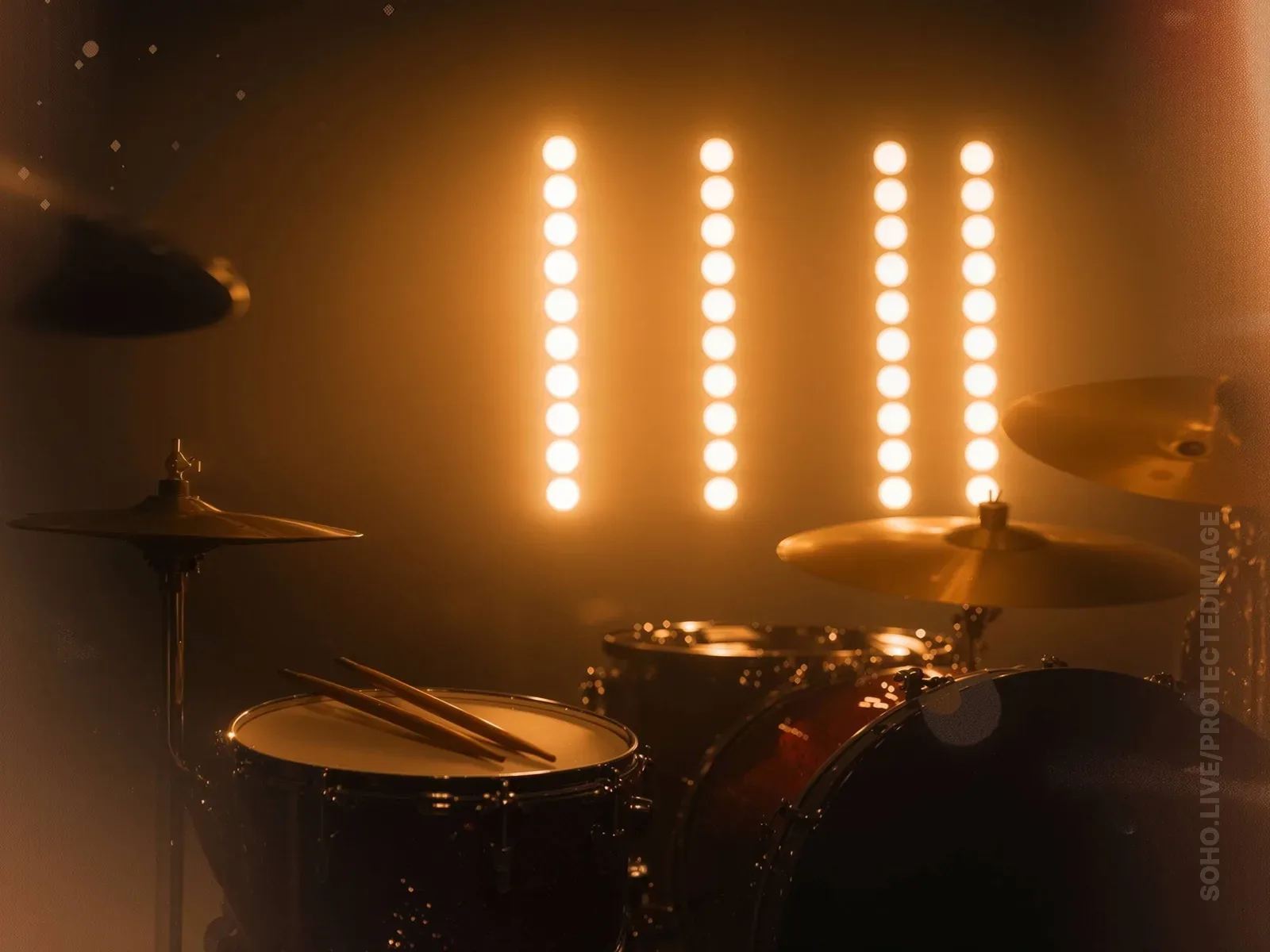 Warm Stage Lights Behind a Drum Kit