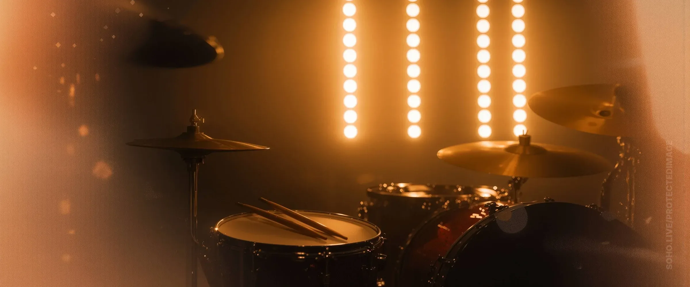 Warm Stage Lights Behind a Drum Kit