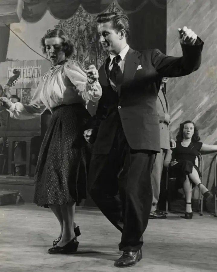 A couple jiving in front of a band, 1948