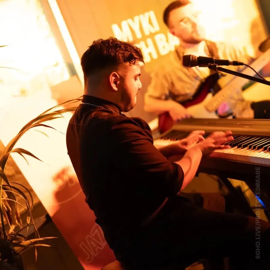 Pablo Barrios at the keys under warm stage light