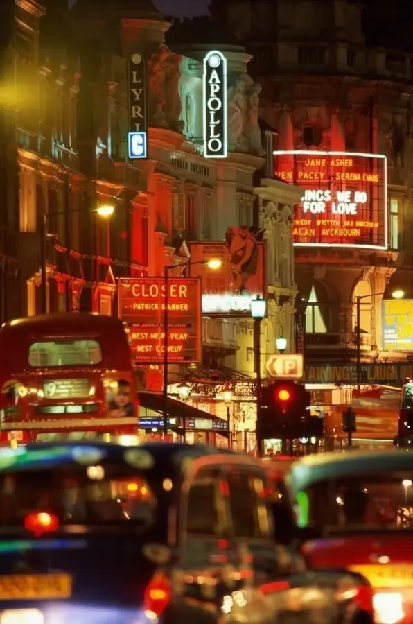 Shaftesbury Avenue at night, theatre neon and traffic
