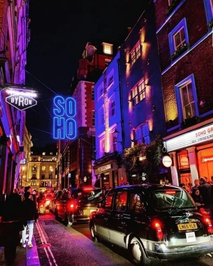 Soho at blue hour, neon signs above a line of cabs