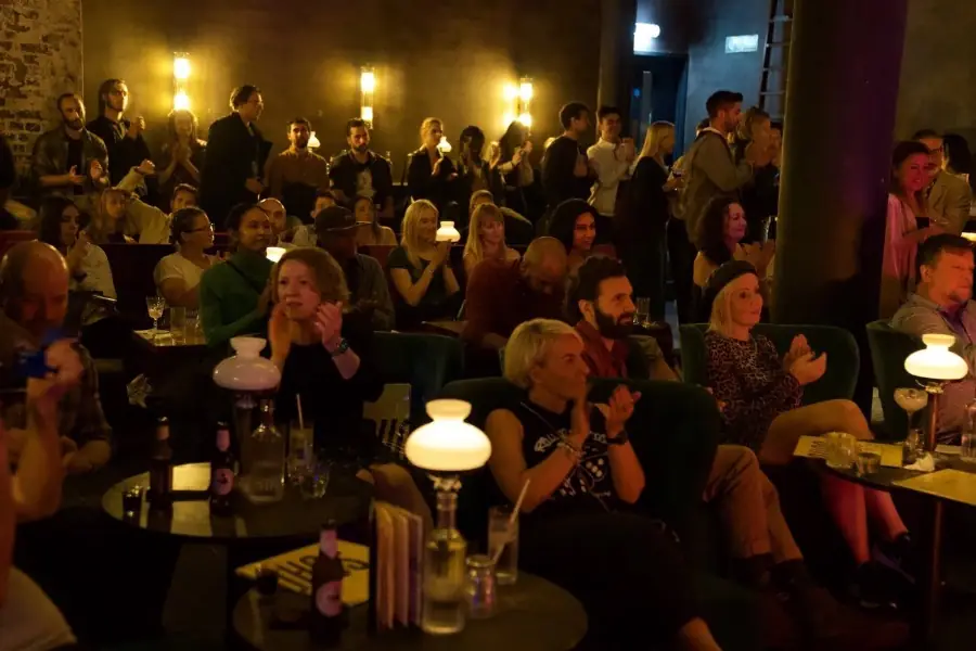A full house at Alfie's Jazz Club, lamps lit on every table