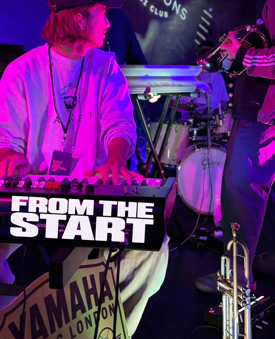 From the Start, a keyboard player on stage with a Yamaha Music London sign
