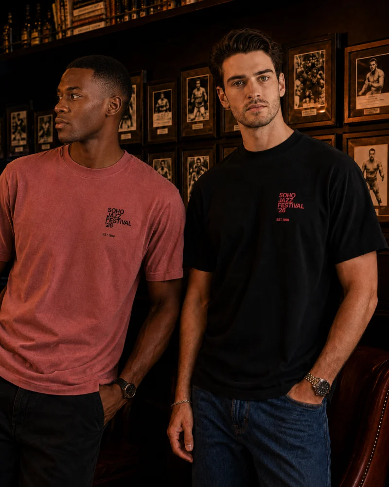 Soho Jazz Festival 2026 tee in vintage black, worn beside the watermelon tee in a Soho bar