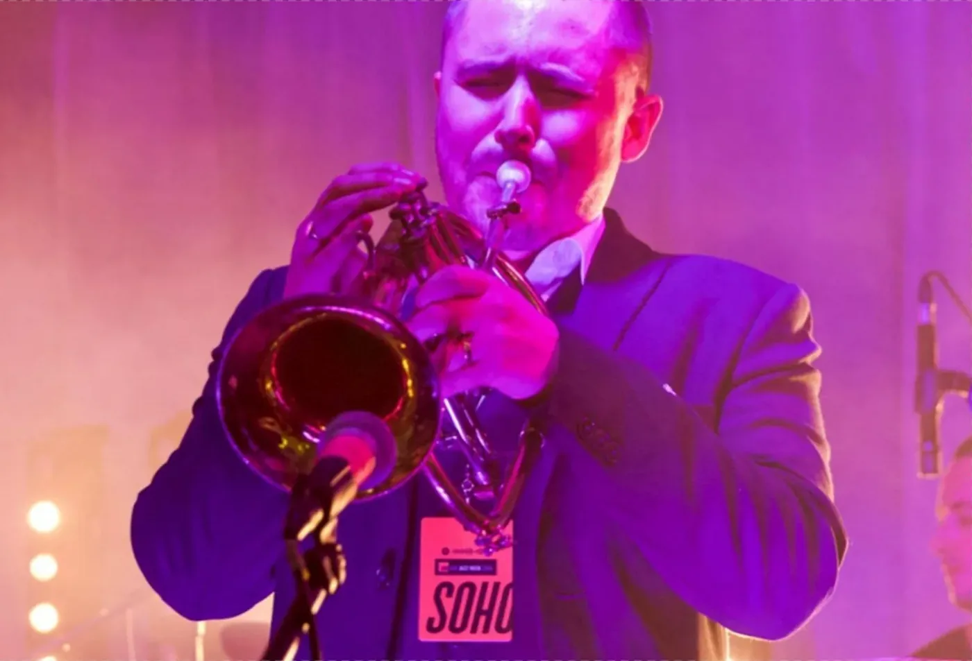 Trumpeter performing under stage lights at Soho Jazz Festival in Soho, London